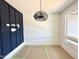 Bright room with a modern light fixture and navy accent wall at 130 Broadleaf Ln, Youngsville, NC 27596