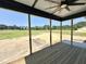 Relaxing screened porch with a ceiling fan overlooking an expansive outdoor space at 130 Broadleaf Ln, Youngsville, NC 27596