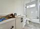 Modern bathroom with white vanity, sleek fixtures, and stylish tile work in the shower and on the floor at 135 Cherry Bark Dr, Youngsville, NC 27596