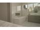 Modern bathroom featuring a standalone soaking tub and sleek vanity with luxurious finishes at 135 Cherry Bark Dr, Youngsville, NC 27596