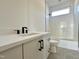Bathroom featuring a vanity with white countertop and tiled shower/tub combo at 135 Cherry Bark Dr, Youngsville, NC 27596