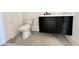 Bathroom showing a toilet and a black vanity with white countertop and gray tile floor at 135 Cherry Bark Dr, Youngsville, NC 27596