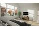 Bright bedroom featuring large windows, neutral decor, and a stylish entertainment center at 135 Cherry Bark Dr, Youngsville, NC 27596