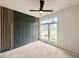 Bedroom featuring a modern accent wall, a ceiling fan, and a large window for ample natural light at 135 Cherry Bark Dr, Youngsville, NC 27596