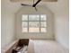 Bedroom features vaulted ceilings, a ceiling fan, and a large window with views of the surrounding landscape at 135 Cherry Bark Dr, Youngsville, NC 27596