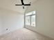 Bright bedroom with a large window allowing ample natural light and a modern ceiling fan at 135 Cherry Bark Dr, Youngsville, NC 27596