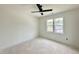 Bright, unfinished bedroom with a modern ceiling fan and large windows offering natural light at 135 Cherry Bark Dr, Youngsville, NC 27596