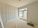 Bright, unfinished bedroom featuring a large window and a striking chevron accent wall design at 135 Cherry Bark Dr, Youngsville, NC 27596