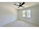 Bright bedroom with a black ceiling fan and a window offering natural light and views at 135 Cherry Bark Dr, Youngsville, NC 27596