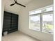 Bright bedroom with built-in shelving and a large window looking out to the neighboring homes at 135 Cherry Bark Dr, Youngsville, NC 27596