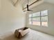 Bedroom with vaulted ceilings, a ceiling fan, and a large window overlooking a wooded view at 135 Cherry Bark Dr, Youngsville, NC 27596