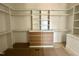 Walk-in closet featuring custom shelving, built-in drawers, and ample storage space at 135 Cherry Bark Dr, Youngsville, NC 27596