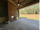 Covered patio with stone floors and a brick fireplace, perfect for outdoor living at 135 Cherry Bark Dr, Youngsville, NC 27596