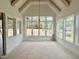 Dining area showcases a large picture window, vaulted ceiling, and modern light fixture at 135 Cherry Bark Dr, Youngsville, NC 27596