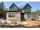 Modern two-story home with mixed siding and stone details, showcasing its contemporary design and curb appeal at 135 Cherry Bark Dr, Youngsville, NC 27596