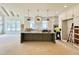 Spacious kitchen features a central island with pendant lighting, white cabinets, and a window providing natural light at 135 Cherry Bark Dr, Youngsville, NC 27596
