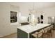 Elegant kitchen featuring a spacious island with barstool seating and modern appliances at 135 Cherry Bark Dr, Youngsville, NC 27596