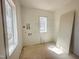 Unfinished laundry room with bright natural light, offering the canvas for your dream design at 135 Cherry Bark Dr, Youngsville, NC 27596