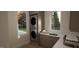 Efficient laundry room with stacked washer and dryer, ample cabinet space, and a sink for added convenience at 135 Cherry Bark Dr, Youngsville, NC 27596