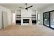 Open living room with a fireplace, built-in shelves, and a sliding glass door at 135 Cherry Bark Dr, Youngsville, NC 27596