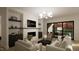 Stylish living room with fireplace, decorative shelving, and a slider leading to the outdoors at 135 Cherry Bark Dr, Youngsville, NC 27596