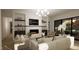 Modern living room with a fireplace, sleek shelving, and comfortable seating, a perfect space to relax at 135 Cherry Bark Dr, Youngsville, NC 27596