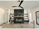 Modern living room featuring a black tile fireplace, built-in shelving, a ceiling fan, and recessed lighting at 135 Cherry Bark Dr, Youngsville, NC 27596