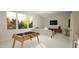 Spacious living room with a foosball table, modern sofa, and large windows offering scenic outdoor views at 135 Cherry Bark Dr, Youngsville, NC 27596