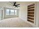 Bright loft with three windows providing natural light, a ceiling fan, and built-in shelving on the side at 135 Cherry Bark Dr, Youngsville, NC 27596