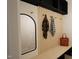 Functional mudroom area featuring a bench, coat hooks, and a mirror for organization and convenience at 135 Cherry Bark Dr, Youngsville, NC 27596