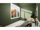 Green home office featuring a large window with scenic outdoor views, a minimalist desk, and modern chair at 135 Cherry Bark Dr, Youngsville, NC 27596