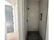 Tiled walk-in shower with black shower head and built-in niche for toiletries at 135 Cherry Bark Dr, Youngsville, NC 27596