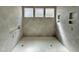Modern shower featuring gray tile, recessed nooks, and a hexagon tile floor, offering a luxurious bathing experience at 135 Cherry Bark Dr, Youngsville, NC 27596