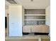 Modern wet bar featuring a tiled backsplash, floating wood shelves and modern sink at 135 Cherry Bark Dr, Youngsville, NC 27596