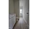 Bathroom featuring a wood-look floor, neutral walls, and a bright window view at 163 Vili Dr, Broadway, NC 27505
