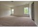 Spacious bedroom featuring neutral walls, carpeting, and natural light from two windows at 163 Vili Dr, Broadway, NC 27505