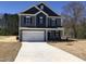 Charming two-story home with a two-car garage and a well-manicured front lawn on a sunny day at 163 Vili Dr, Broadway, NC 27505