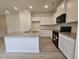 Bright kitchen features granite countertops, stainless steel sink in the island, black appliances, and wood flooring at 163 Vili Dr, Broadway, NC 27505