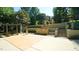 Beautifully landscaped backyard with patio, water feature, and steps leading to an elevated garden, perfect for outdoor relaxation at 2213 Weybridge Dr, Raleigh, NC 27615