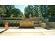 This well-manicured backyard features a stone water feature, lush landscaping, and a serene garden for ultimate relaxation and privacy at 2213 Weybridge Dr, Raleigh, NC 27615