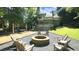 Outdoor entertaining space with adirondack chairs surrounding a stone fire pit at 2213 Weybridge Dr, Raleigh, NC 27615