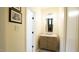 Hallway bathroom featuring a marble sink and decorative mirror and walls at 2213 Weybridge Dr, Raleigh, NC 27615