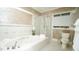 Bright bathroom featuring a separate tub and glass-enclosed shower at 2213 Weybridge Dr, Raleigh, NC 27615