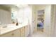 Bathroom featuring double sinks, patterned wallpaper, and a doorway to the bedroom at 2213 Weybridge Dr, Raleigh, NC 27615