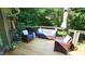 Cozy deck featuring comfortable seating with blue cushions and a large umbrella, surrounded by lush greenery at 2213 Weybridge Dr, Raleigh, NC 27615
