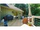 Inviting outdoor deck with a grill, lounge seating, and an umbrella for relaxing and entertaining at 2213 Weybridge Dr, Raleigh, NC 27615