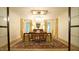 Formal dining room featuring a grand chandelier, elegant curtains, and a large table with seating for sophisticated entertaining at 2213 Weybridge Dr, Raleigh, NC 27615