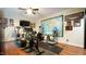 Well-equipped home gym features an array of exercise equipment and hardwood floors at 2213 Weybridge Dr, Raleigh, NC 27615