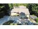 Stunning home with mature trees, featuring a stone and concrete driveway leading to its inviting entrance and well-manicured landscaping at 2213 Weybridge Dr, Raleigh, NC 27615