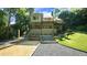 Beautiful exterior of home with multi tiered deck, landscaping, and gravel areas at 2213 Weybridge Dr, Raleigh, NC 27615